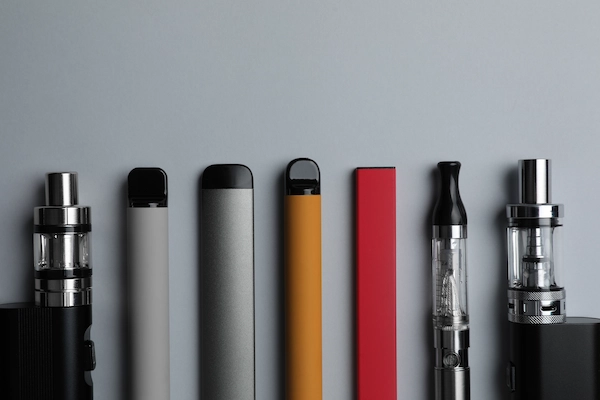 Assortment of different types of vapes, from disposables to cartridge-style.