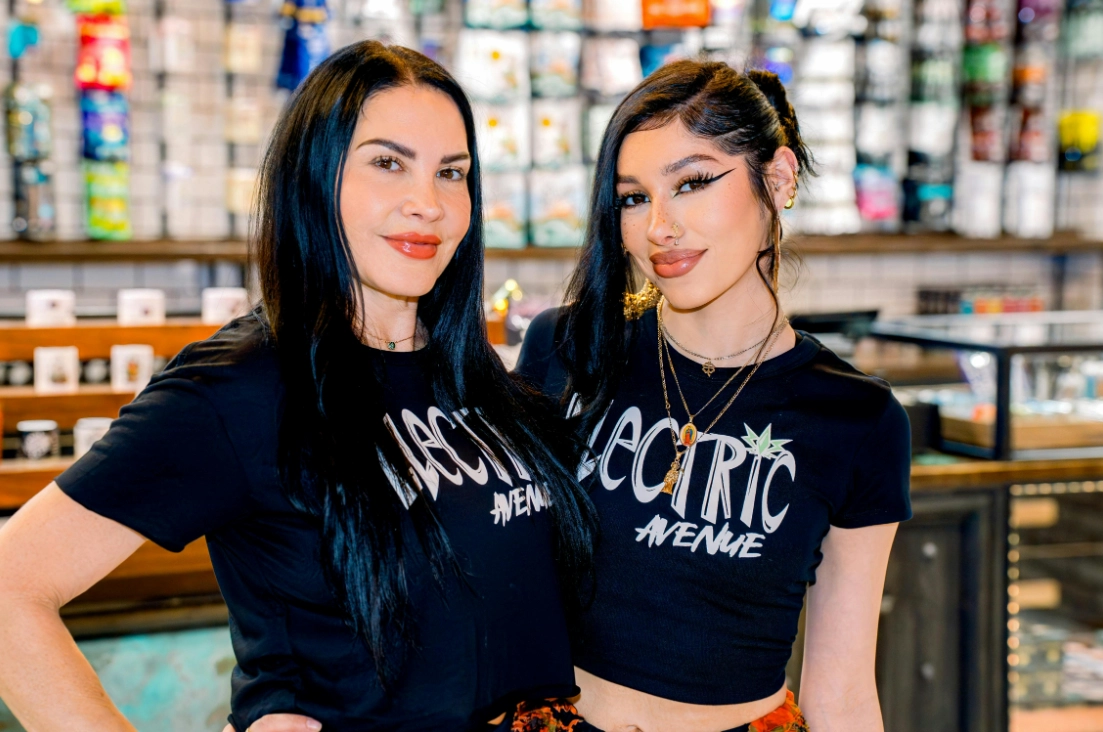 Electric Avenue's budtenders smiling in front of the counter.